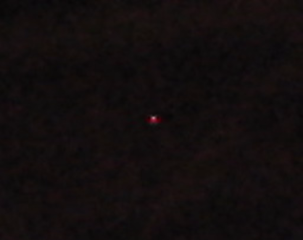 Close crop of a singular hot pixel on a camera sensor image.