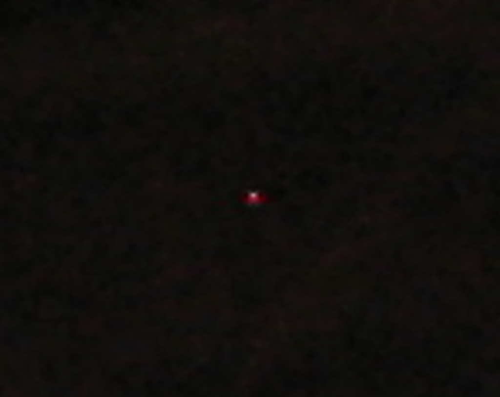 Close crop of a singular hot pixel on a camera sensor image.